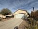 A single-story home with a two car garage and low maintenance desert landscaping at 3508 Kittiwake Rd, North Las Vegas, NV 89084