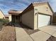 Single-story home with desert landscaping, covered front porch, and two car garage at 3508 Kittiwake Rd, North Las Vegas, NV 89084