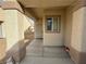 Covered front porch area leading to a security door entrance at 3508 Kittiwake Rd, North Las Vegas, NV 89084