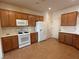 Functional kitchen featuring tile floors, laminate counters, and ample storage space at 3508 Kittiwake Rd, North Las Vegas, NV 89084