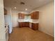 Functional kitchen featuring white appliances, laminate counters, and tile floors at 3508 Kittiwake Rd, North Las Vegas, NV 89084