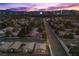 Breathtaking aerial view of a residential community with the Las Vegas skyline at dusk at 3706 Etendre Ct, Las Vegas, NV 89121