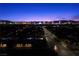 Picturesque nighttime aerial view of homes with the Las Vegas skyline twinkling in the distance at 3706 Etendre Ct, Las Vegas, NV 89121