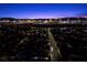 Expansive aerial view showing a residential area and the glittering Las Vegas skyline at night at 3706 Etendre Ct, Las Vegas, NV 89121