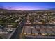 Peaceful neighborhood street merging into an aerial view of the vibrant Las Vegas Strip at twilight at 3706 Etendre Ct, Las Vegas, NV 89121