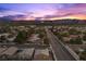 Stunning aerial view of a charming community with the iconic Las Vegas skyline silhouetted at sunset at 3706 Etendre Ct, Las Vegas, NV 89121