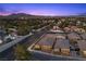 Sunset aerial view showcases a charming community nestled against a stunning mountain backdrop at 3706 Etendre Ct, Las Vegas, NV 89121
