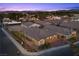 An aerial view of single-Gathering homes and landscaped street, with palm trees lining the street and community at 3706 Etendre Ct, Las Vegas, NV 89121