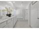 Elegant bathroom with double sinks, white cabinetry, large mirrors, and a separate glass-enclosed shower and tub at 3706 Etendre Ct, Las Vegas, NV 89121