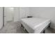 Minimalist bedroom with light, neutral carpet, white walls, and access to a bathroom at 3706 Etendre Ct, Las Vegas, NV 89121