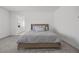 Bright bedroom featuring a comfortable bed with soft, neutral-toned bedding and a glimpse of an en suite bathroom at 3706 Etendre Ct, Las Vegas, NV 89121