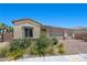 Charming single-story home boasts a three-car garage, desert landscaping, and a brick-paved driveway at 3706 Etendre Ct, Las Vegas, NV 89121