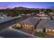 Inviting single-story home with a brick driveway, three-car garage, and meticulously landscaped front yard near tree lined street at 3706 Etendre Ct, Las Vegas, NV 89121