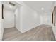 Bright hallway boasts wood floors and clean, white walls leading to various rooms at 3706 Etendre Ct, Las Vegas, NV 89121