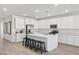 Modern kitchen featuring white cabinets, stainless steel appliances, and a large center island with seating at 3706 Etendre Ct, Las Vegas, NV 89121