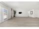 Bright, open living room with sliding glass doors and modern minimalist decor at 3706 Etendre Ct, Las Vegas, NV 89121