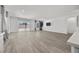Open-concept living room featuring wood-look flooring, a sliding glass door, and modern decor at 3706 Etendre Ct, Las Vegas, NV 89121