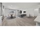 Bright, airy living room featuring contemporary furniture and a dining area with large windows at 3706 Etendre Ct, Las Vegas, NV 89121