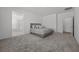 Spacious main bedroom with plush carpeting and access to the attached bathroom with a soaking tub and a glass-enclosed shower at 3706 Etendre Ct, Las Vegas, NV 89121