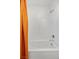 Shower-tub combination featuring an orange shower curtain, a white subway tile surround, and sleek silver fixtures at 3706 Etendre Ct, Las Vegas, NV 89121