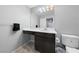 Half bathroom features dark wood cabinetry, white countertops and modern fixtures at 3854 Stadium Ave, Las Vegas, NV 89120