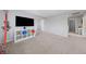 View of large bonus room with a mounted TV, neutral carpet, and adjacent rooms at 3854 Stadium Ave, Las Vegas, NV 89120