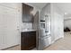 Kitchen area features stainless refrigerator, granite counters, and convenient access to the garage at 3854 Stadium Ave, Las Vegas, NV 89120