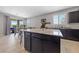 Spacious kitchen featuring granite countertops and an open layout with a sliding glass door to the backyard at 3854 Stadium Ave, Las Vegas, NV 89120