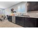 Modern kitchen featuring dark cabinets, granite countertops, and stainless steel appliances at 3854 Stadium Ave, Las Vegas, NV 89120