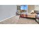 Comfortable bedroom with a large window, neutral carpet, and a striped comforter at 3930 University Center Dr # 603, Las Vegas, NV 89119