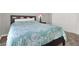 Cozy bedroom features neutral walls and carpet, with an accent-patterned comforter at 3930 University Center Dr # 603, Las Vegas, NV 89119