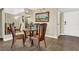 Cozy dining area features wood floors, a modern light fixture, and views into the living space at 3930 University Center Dr # 603, Las Vegas, NV 89119