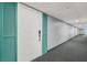 Hallway features carpet flooring with views of the unit's entrance door with teal shutters at 3930 University Center Dr # 603, Las Vegas, NV 89119