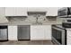 Modern kitchen featuring white cabinets, stainless steel appliances, and updated fixtures at 3930 University Center Dr # 603, Las Vegas, NV 89119