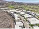 Aerial view of a neighborhood with modern architecture showcasing uniform styles in a desert environment at 414 Tranquil Peak Ct, Henderson, NV 89012