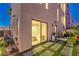 Outdoor living space with sliding glass doors, stone pavers, and minimalist landscaping at 414 Tranquil Peak Ct, Henderson, NV 89012