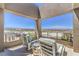 Comfortable covered balcony with seating and sweeping views of the surrounding area at 414 Tranquil Peak Ct, Henderson, NV 89012