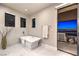Luxurious bathroom with soaking tub and city views at 414 Tranquil Peak Ct, Henderson, NV 89012