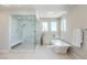 Bathroom features a walk-in shower, modern bathtub, and bright windows at 414 Tranquil Peak Ct, Henderson, NV 89012