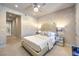 Stylish bedroom featuring a neutral color palette, carpet floors, and elegant mirrored nightstands at 414 Tranquil Peak Ct, Henderson, NV 89012