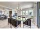 Elegant dining room with glass table, seating for six, and contemporary lighting fixtures at 414 Tranquil Peak Ct, Henderson, NV 89012