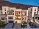 Beautiful exterior view of the 3-story homes, featuring modern design and garages at 414 Tranquil Peak Ct, Henderson, NV 89012