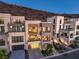 Gorgeous modern home exterior features multiple balconies, garage, and lush landscaping at 414 Tranquil Peak Ct, Henderson, NV 89012