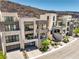Beautiful multi-story home with balconies, modern architecture, glass garage doors, and desert landscaping at 414 Tranquil Peak Ct, Henderson, NV 89012