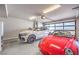 Spacious garage featuring two cars, an epoxy floor, and overhead lighting at 414 Tranquil Peak Ct, Henderson, NV 89012