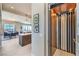 Hallway featuring an elevator and an open view of the dining and kitchen area at 414 Tranquil Peak Ct, Henderson, NV 89012