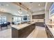 Open-concept kitchen with an island, modern pendant lighting, and views of the living space at 414 Tranquil Peak Ct, Henderson, NV 89012