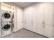 Laundry room features a stacked washer and dryer and ample storage space at 414 Tranquil Peak Ct, Henderson, NV 89012