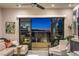 Cozy living room with a view of city lights through a sliding glass door at 414 Tranquil Peak Ct, Henderson, NV 89012