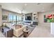 Spacious living room with fireplace, large windows, modern decor, and comfortable seating arrangement at 414 Tranquil Peak Ct, Henderson, NV 89012